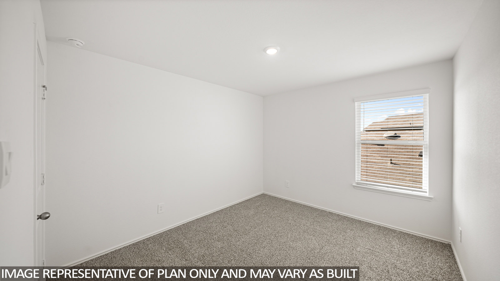 Secondary bedroom with carpet flooring