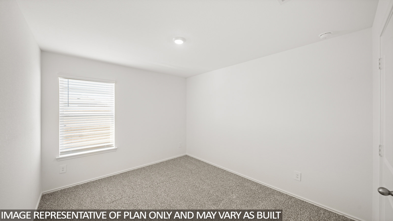 Secondary bedroom with carpet flooring