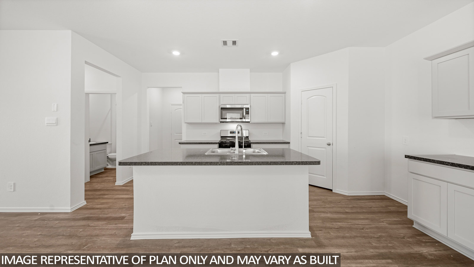 Kitchen with an island and vinyl floor