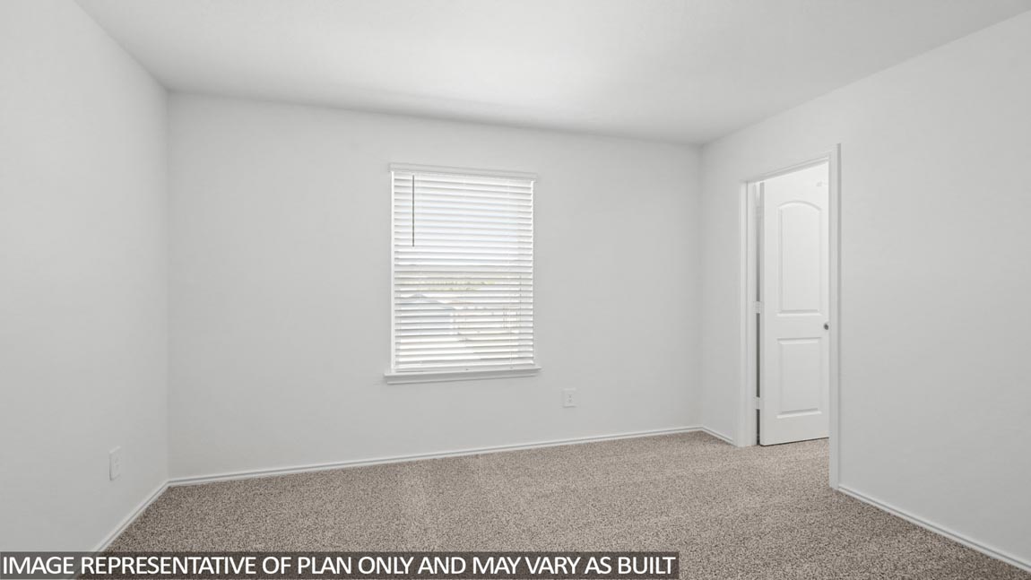 Secondary bedroom with carpet flooring