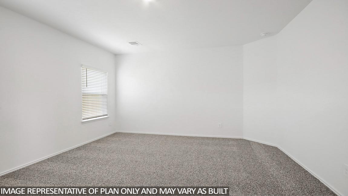 Primary bedroom with carpet flooring