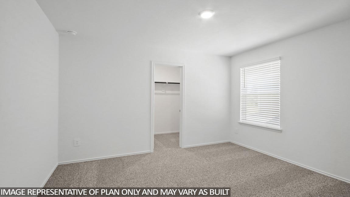 Secondary bedroom with carpet flooring