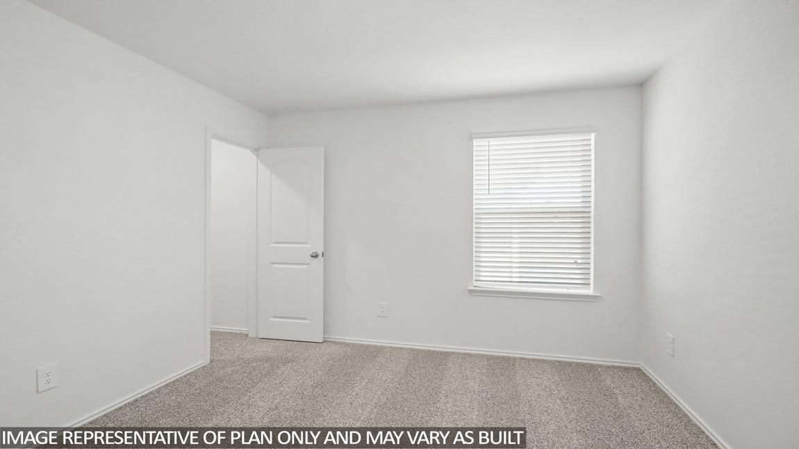 Secondary bedroom with carpet flooring