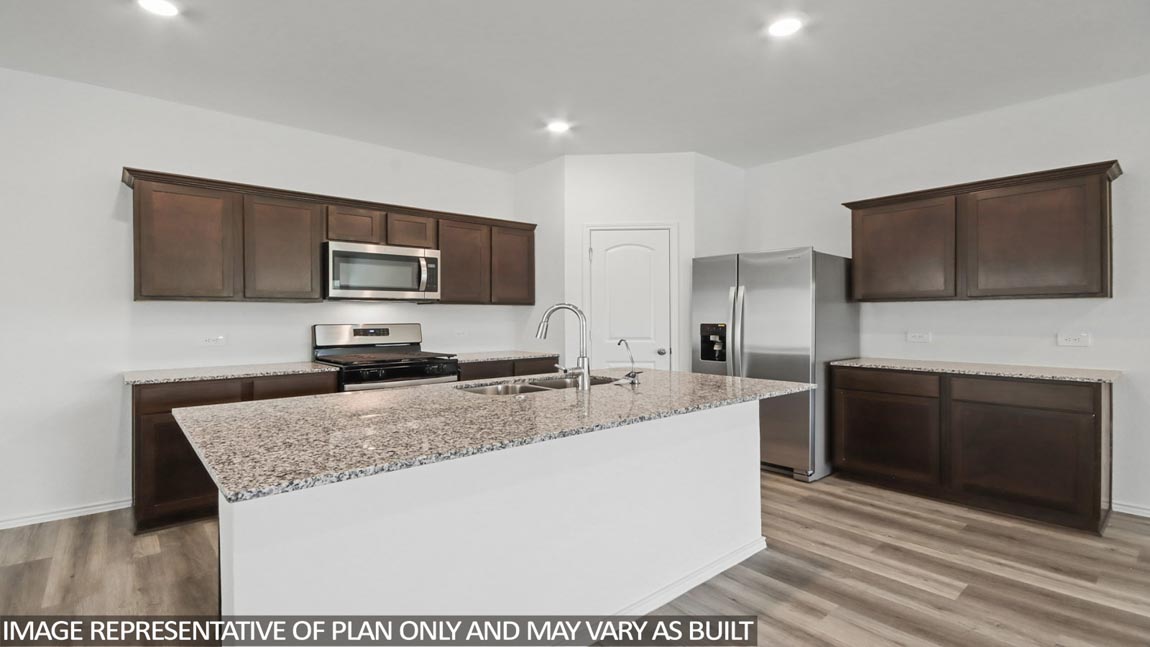 Kitchen with an island and vinyl floor