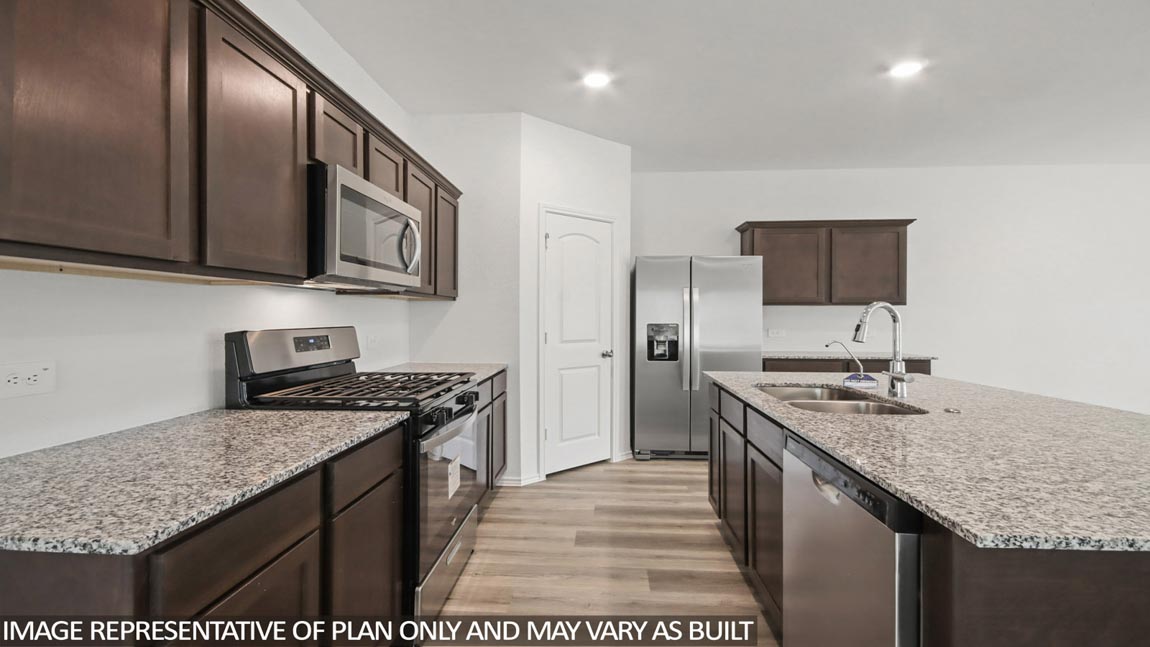 Kitchen with an island and vinyl floor