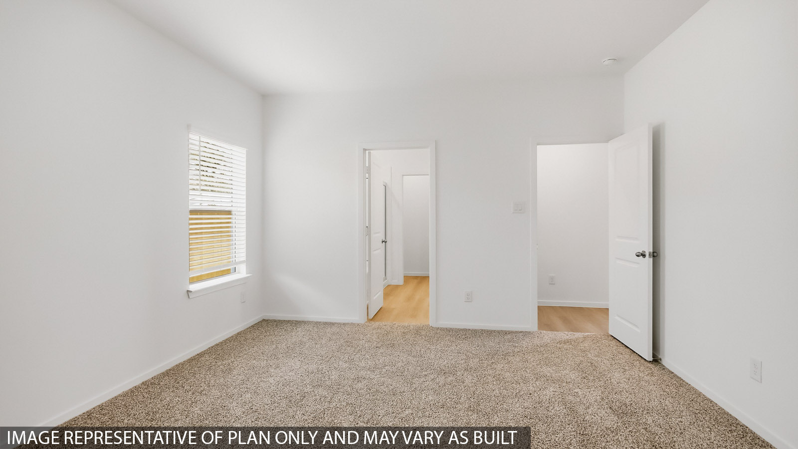 Secondary bedroom with carpet flooring
