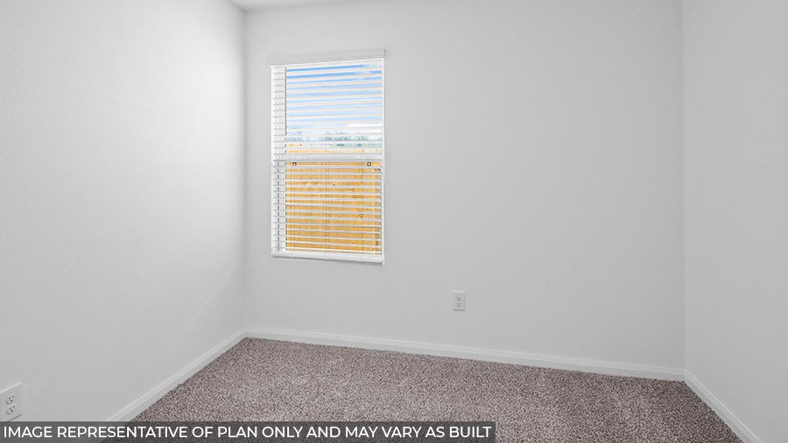 Secondary bedroom with carpet flooring and a bright window.