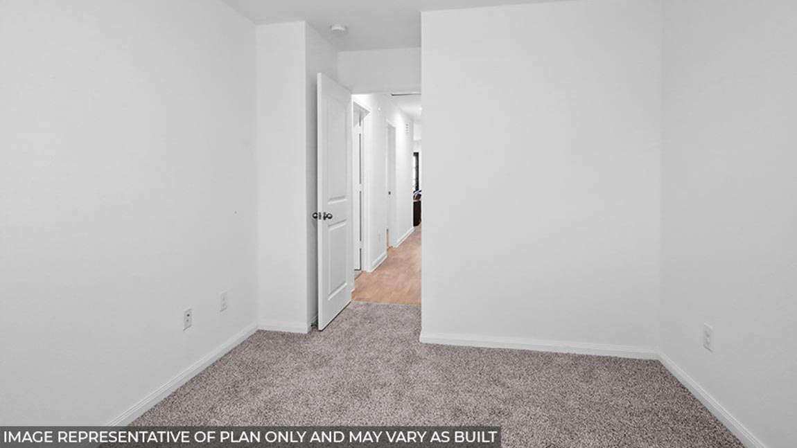 Primary bedroom with carpet flooring.