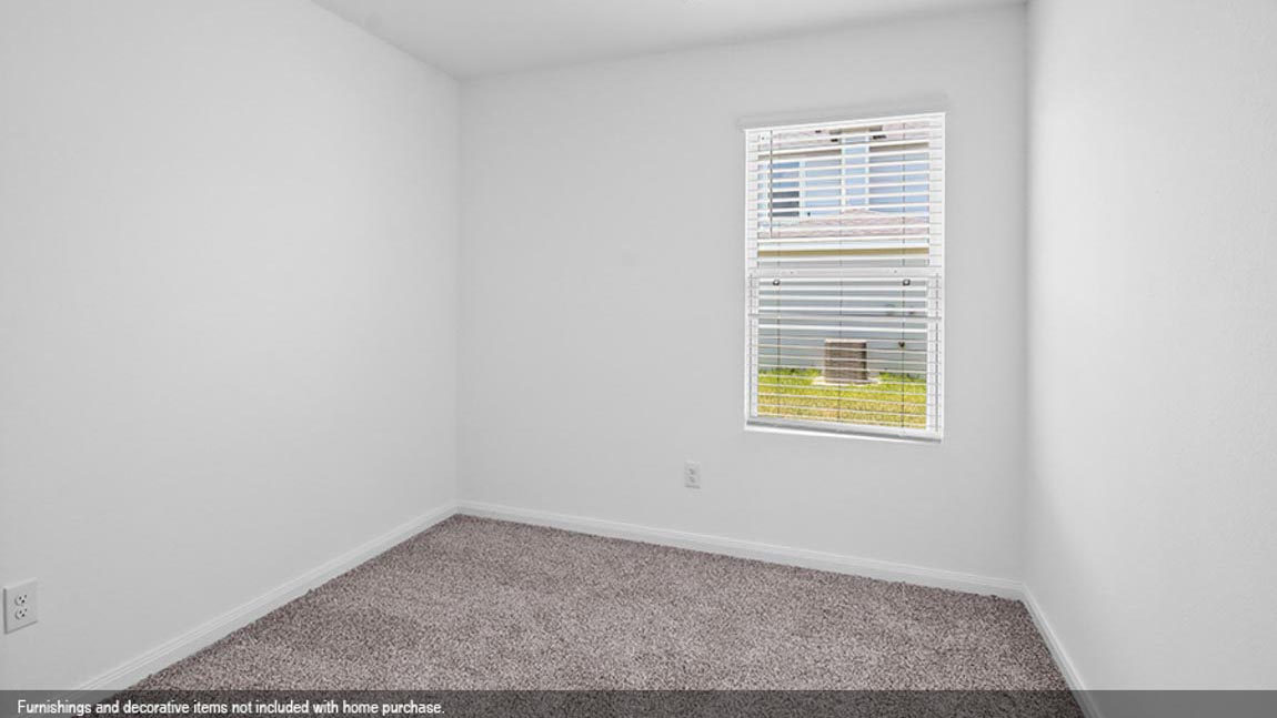 Secondary bedroom with carpet flooring and a bright window.