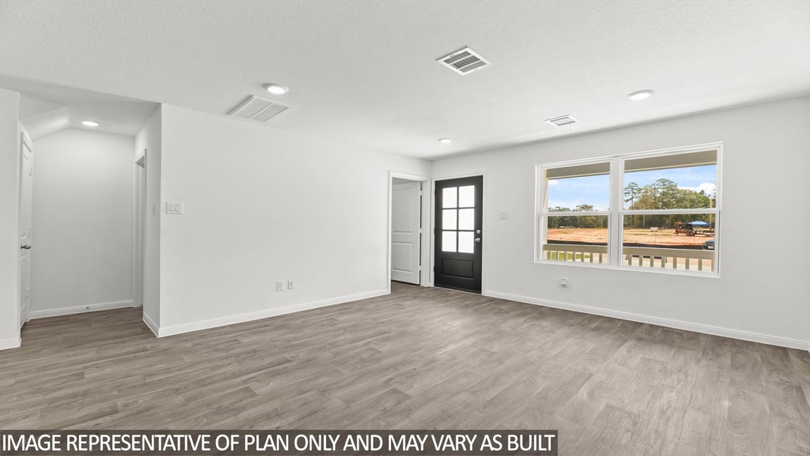 Open concept living and dining area with vinyl flooring and bright windows.