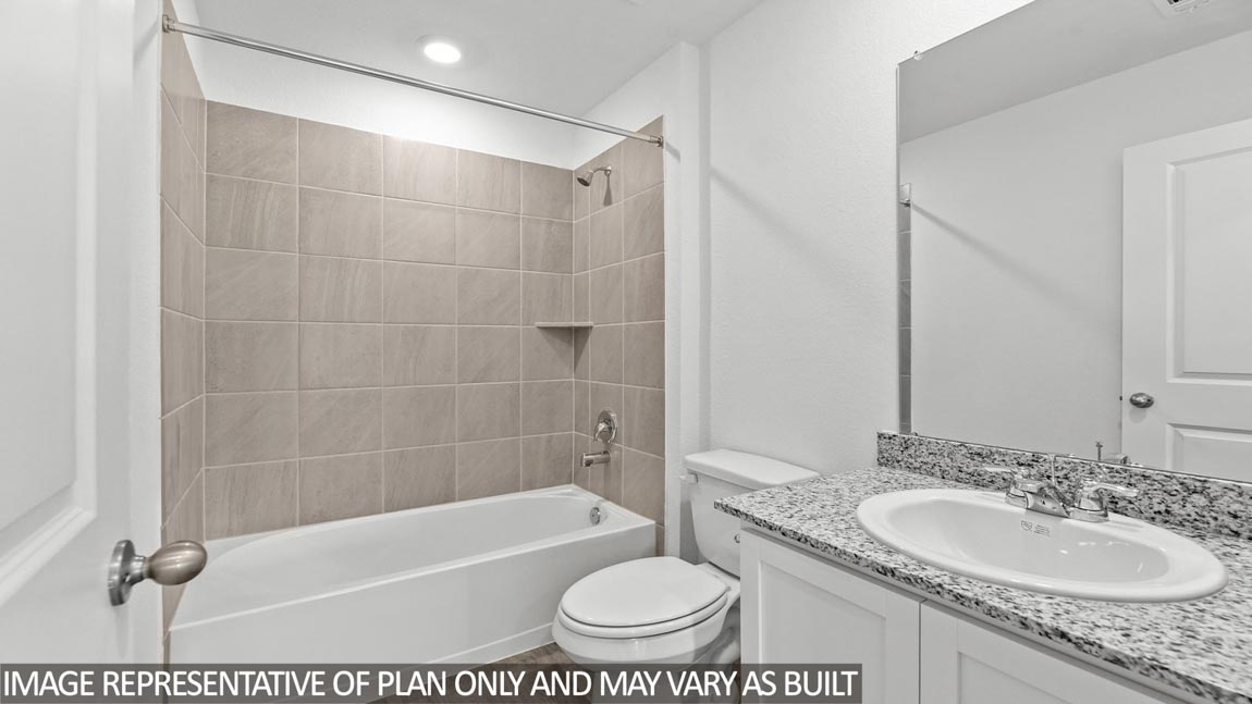 Secondary bathroom with vinyl flooring and a tile tub/shower combo.