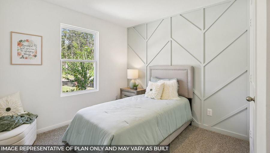 Secondary bedroom with carpet flooring
