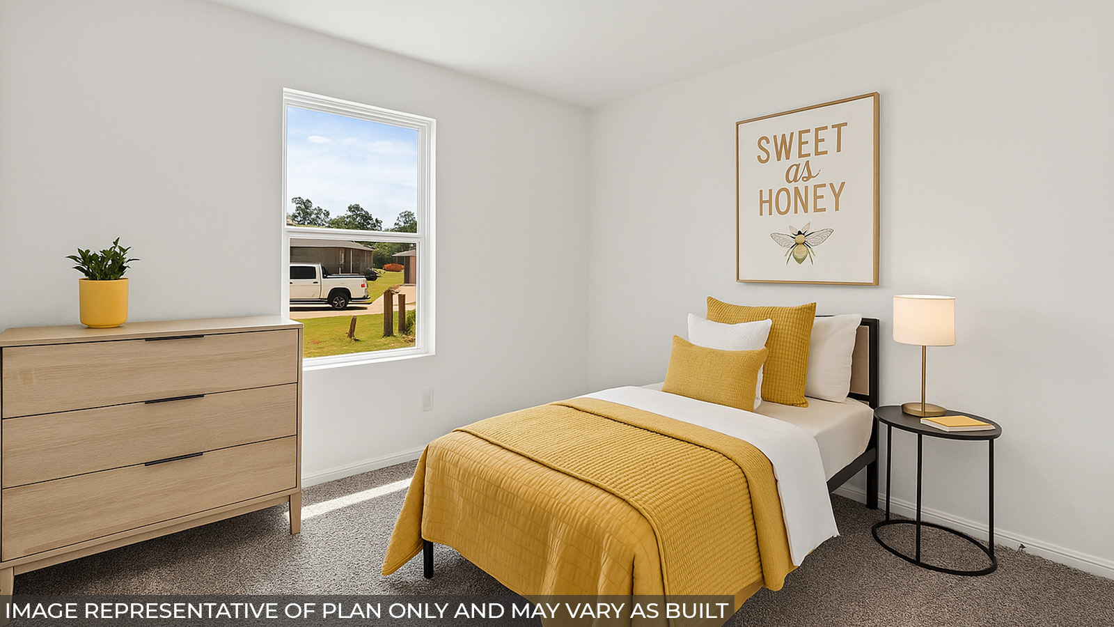 Staged secondary bedroom with carpet flooring and a bright window.