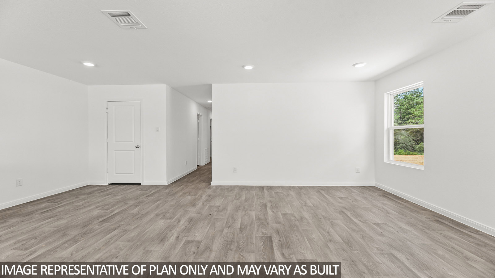 Spacious living area with vinyl flooring
