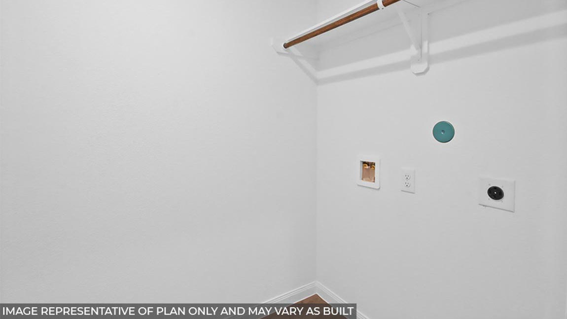 Utility room with overhead storage space.