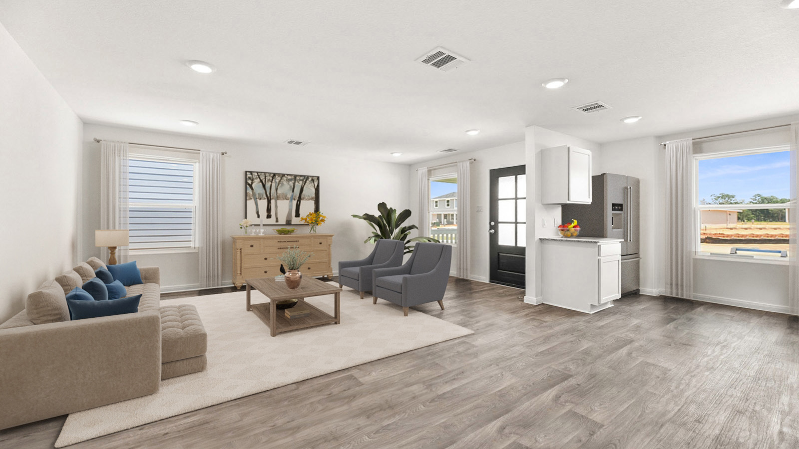 Staged living room with vinyl flooring and bright windows.