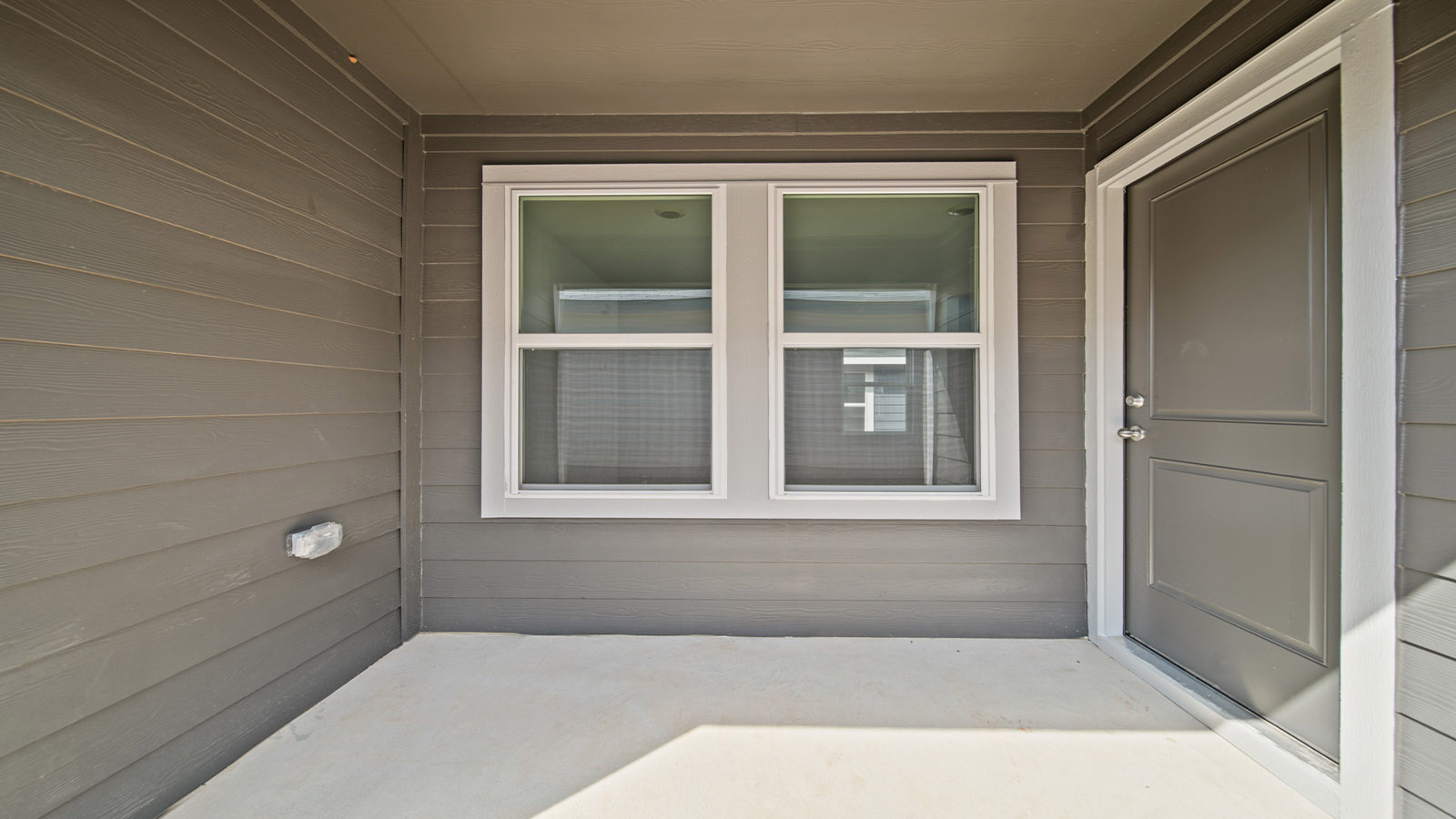 Backyard with back patio and overhead light.