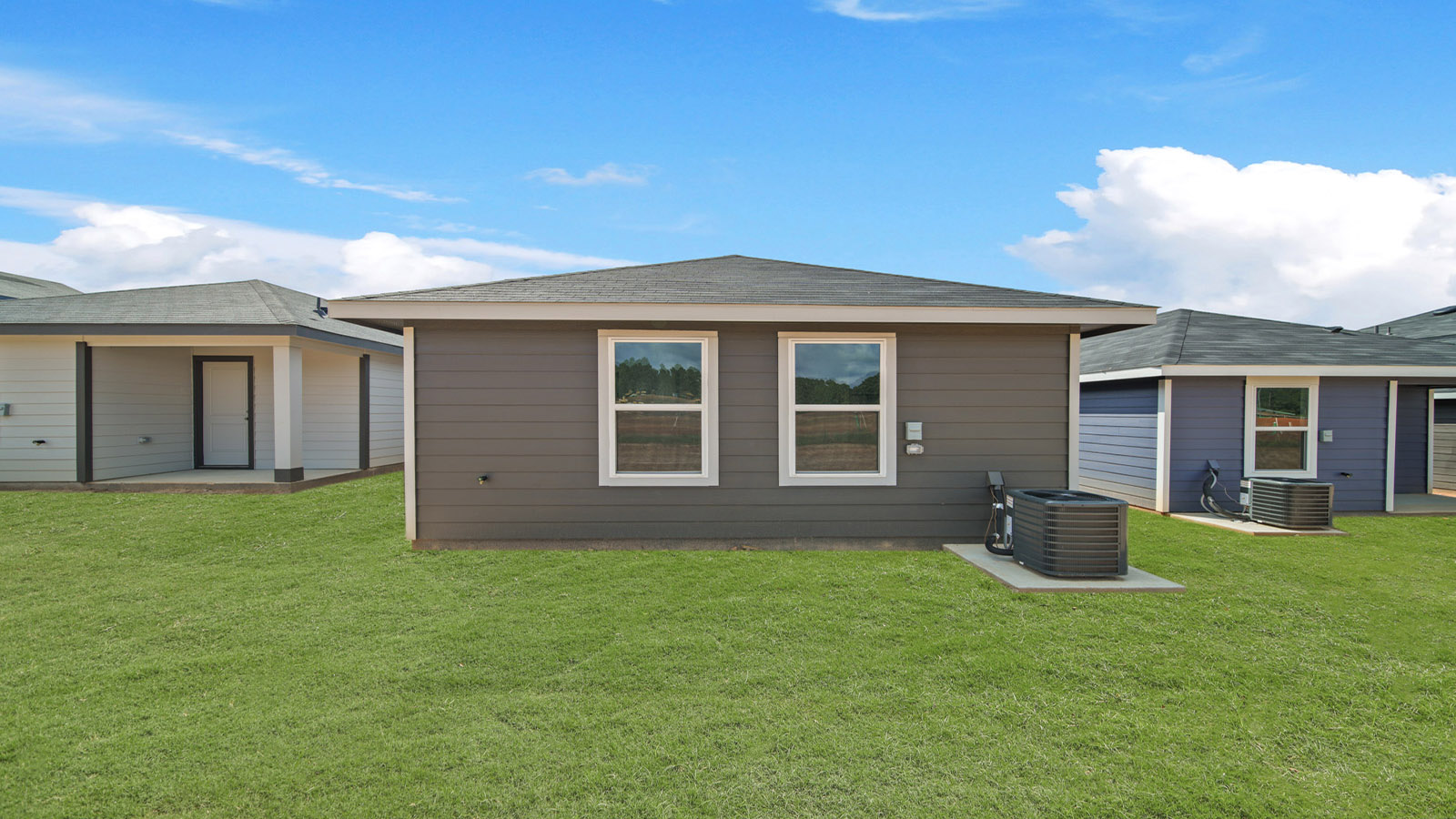 Backyard with back patio and overhead light.