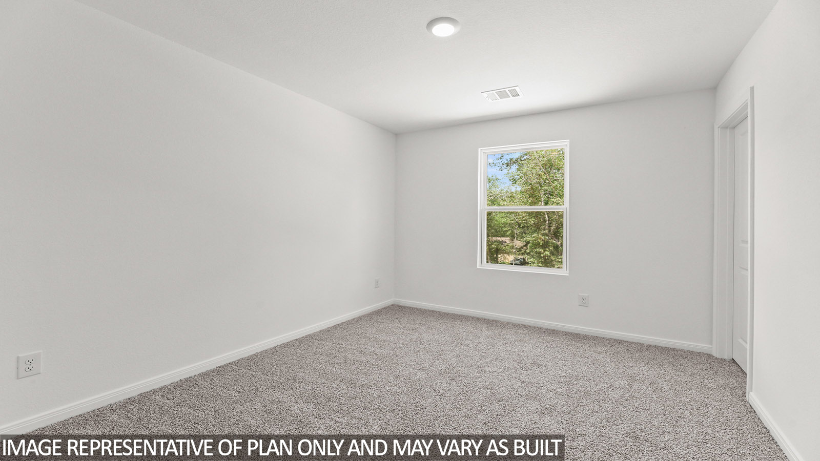 Secondary bedroom with carpet flooring