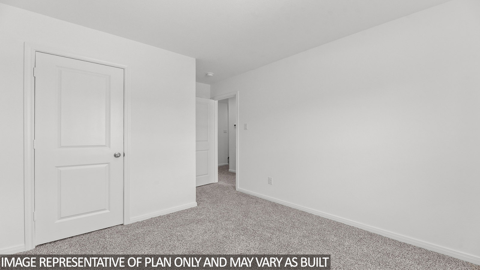 Primary bedroom with carpet flooring