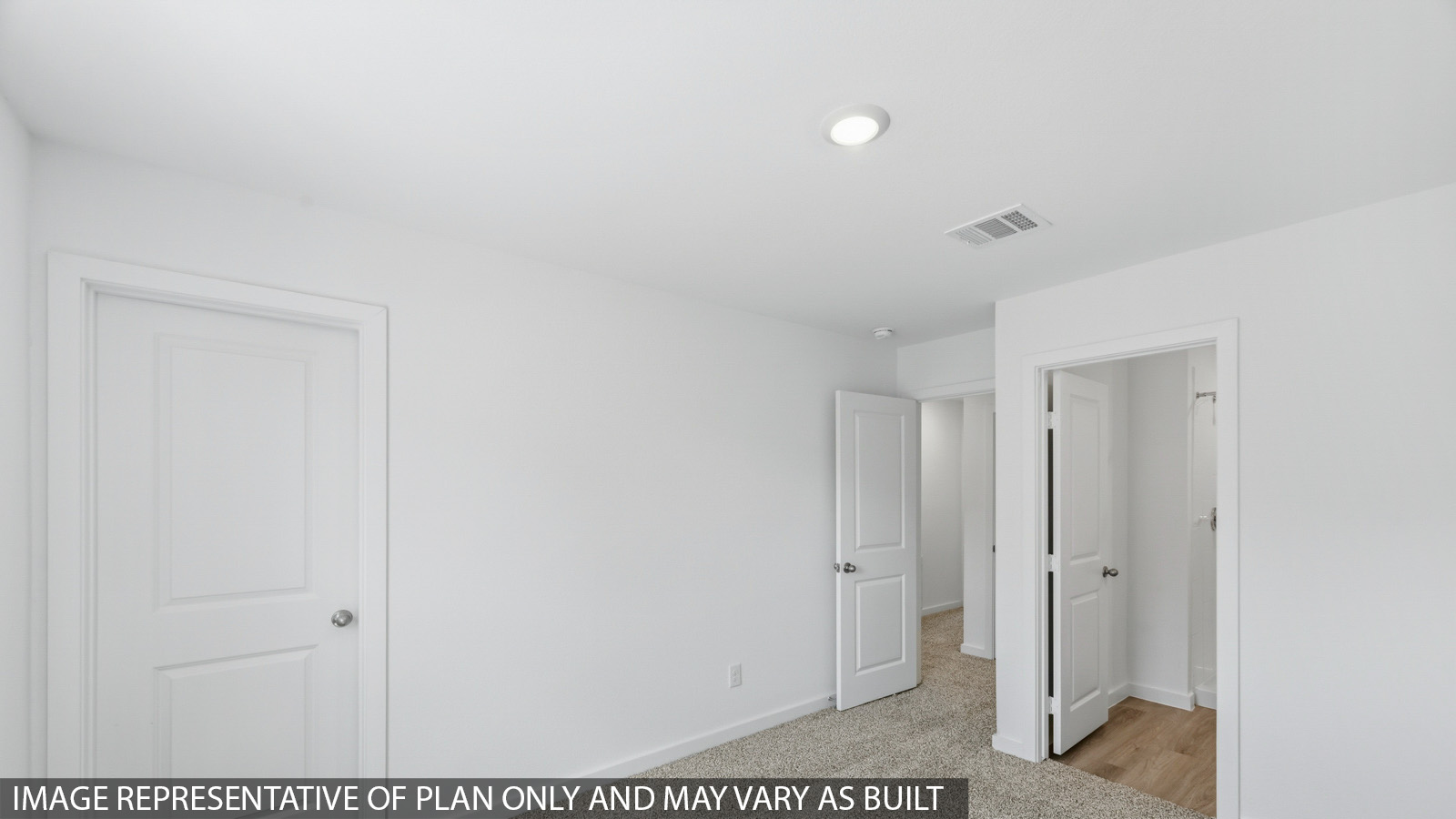 Secondary bedroom with carpet flooring