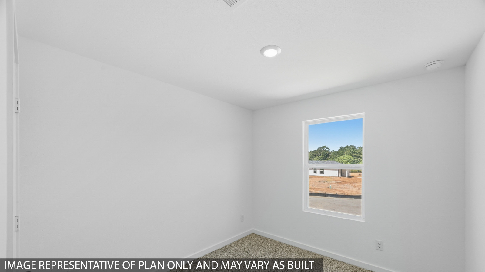 Secondary bedroom with carpet flooring