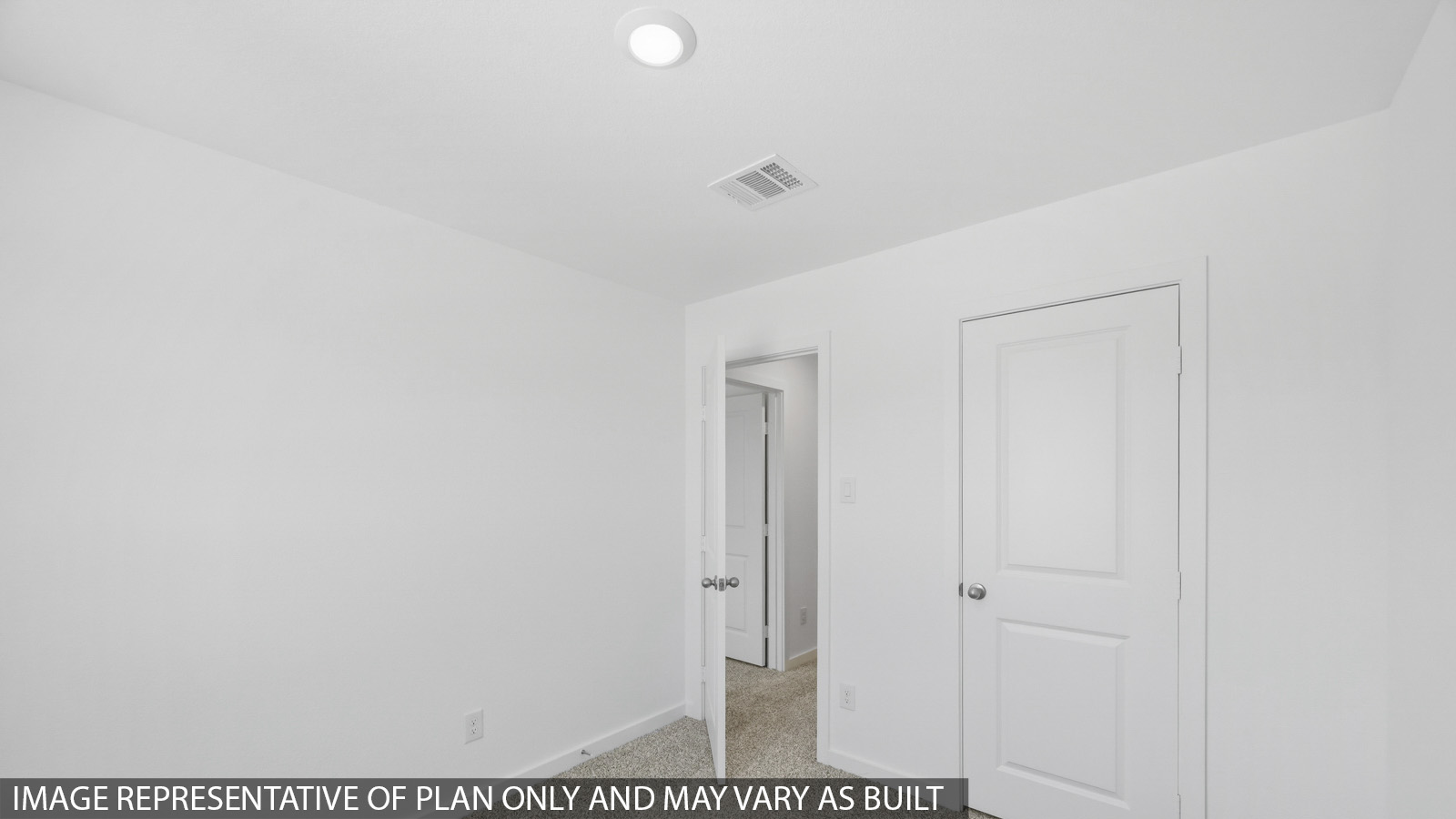 Secondary bedroom with carpet flooring