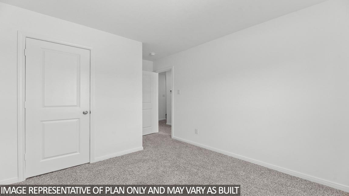 Secondary bedroom with carpet flooring