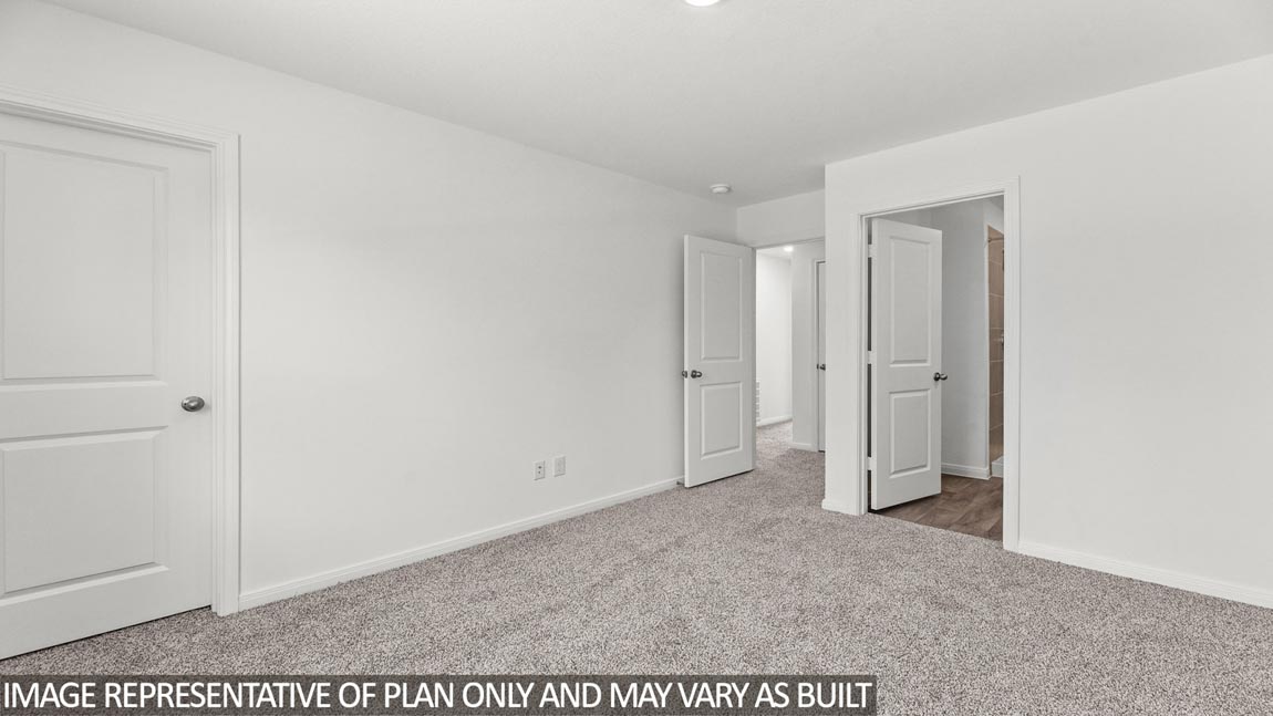 Secondary bedroom with carpet flooring