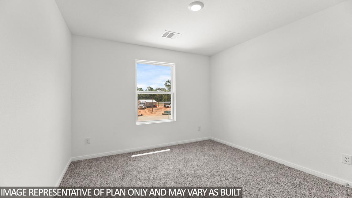 Primary bedroom with carpet flooring