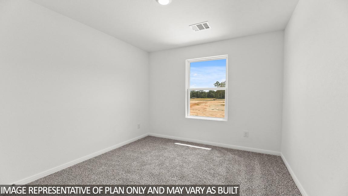 Primary bedroom with carpet flooring