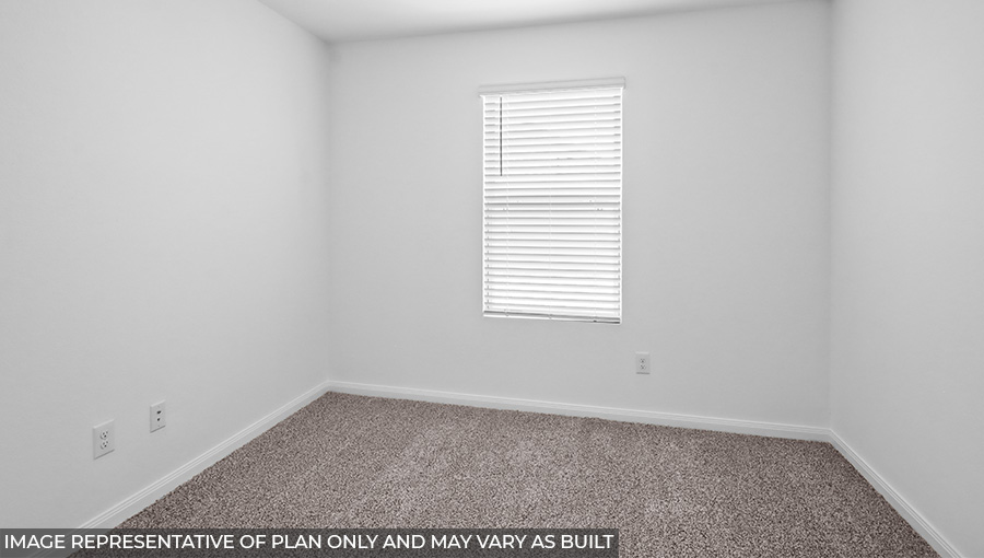 Secondary bedroom with carpet flooring