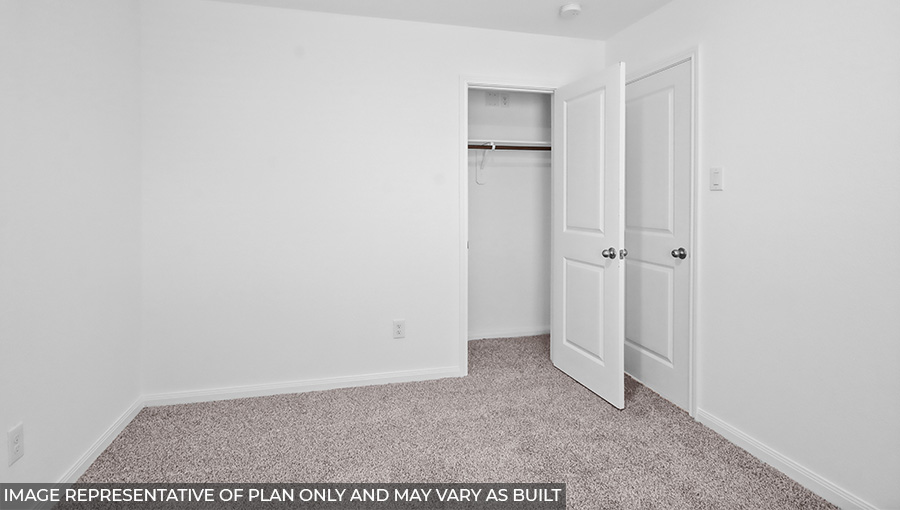 Secondary bedroom with carpet flooring