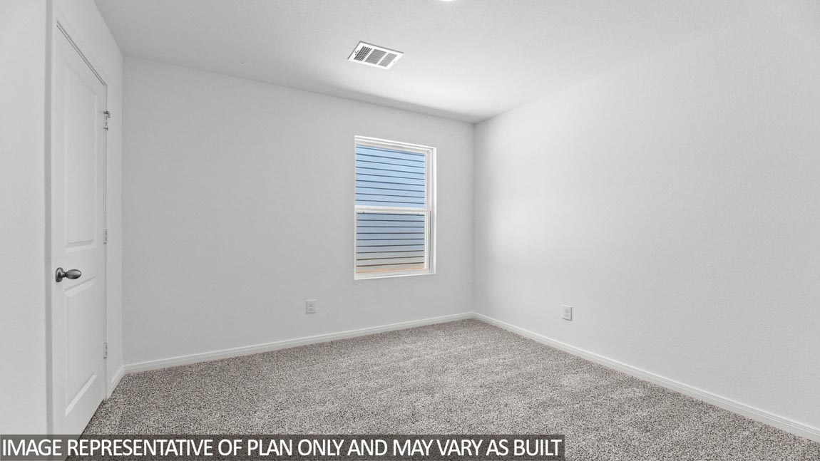 Secondary bedroom with carpet flooring