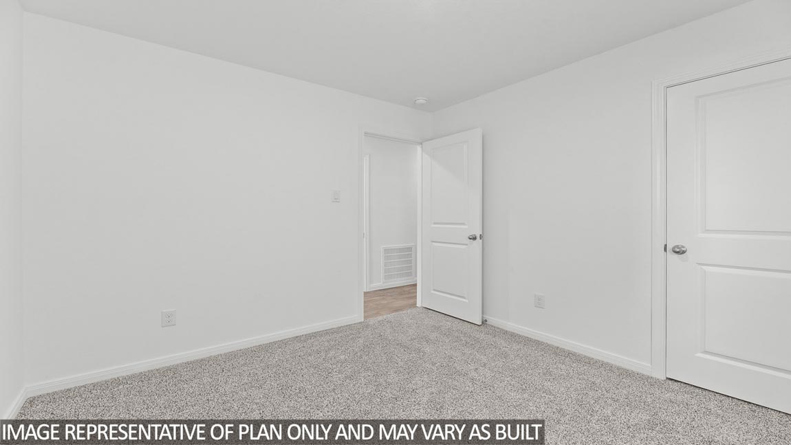 Primary bedroom with carpet flooring