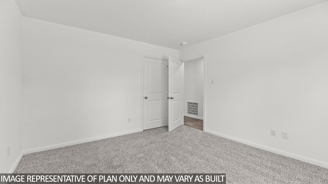Secondary bedroom with carpet flooring