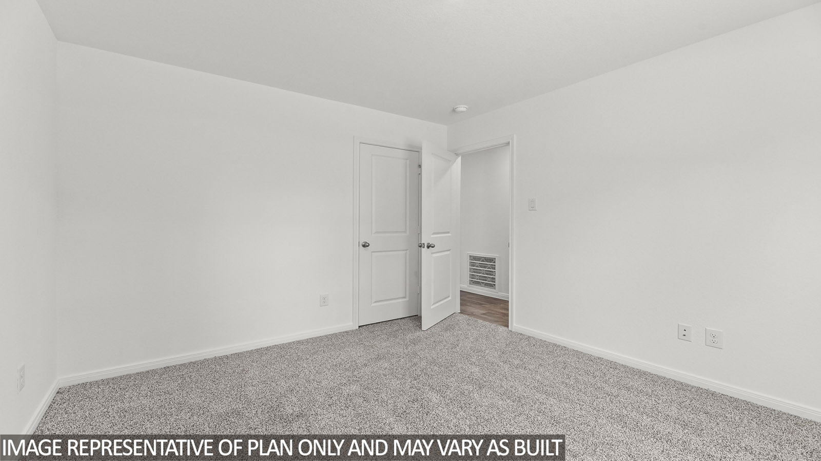 Secondary bedroom with carpet flooring