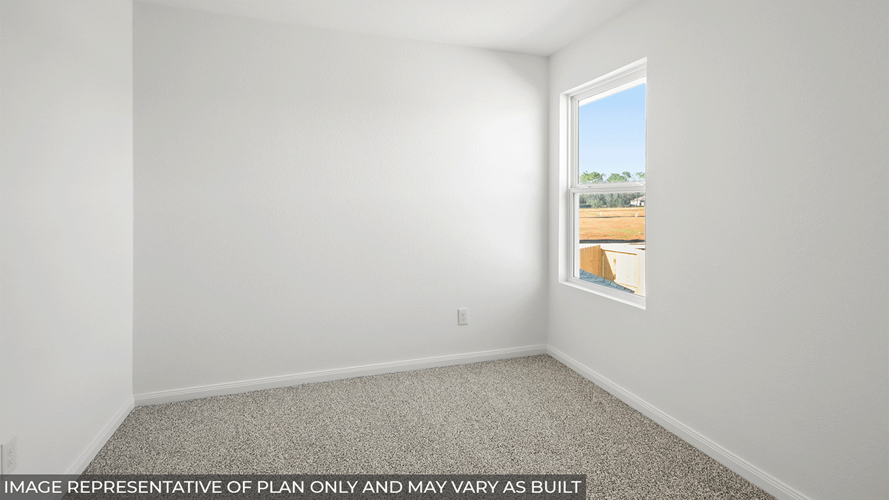 Secondary bedroom with carpet flooring