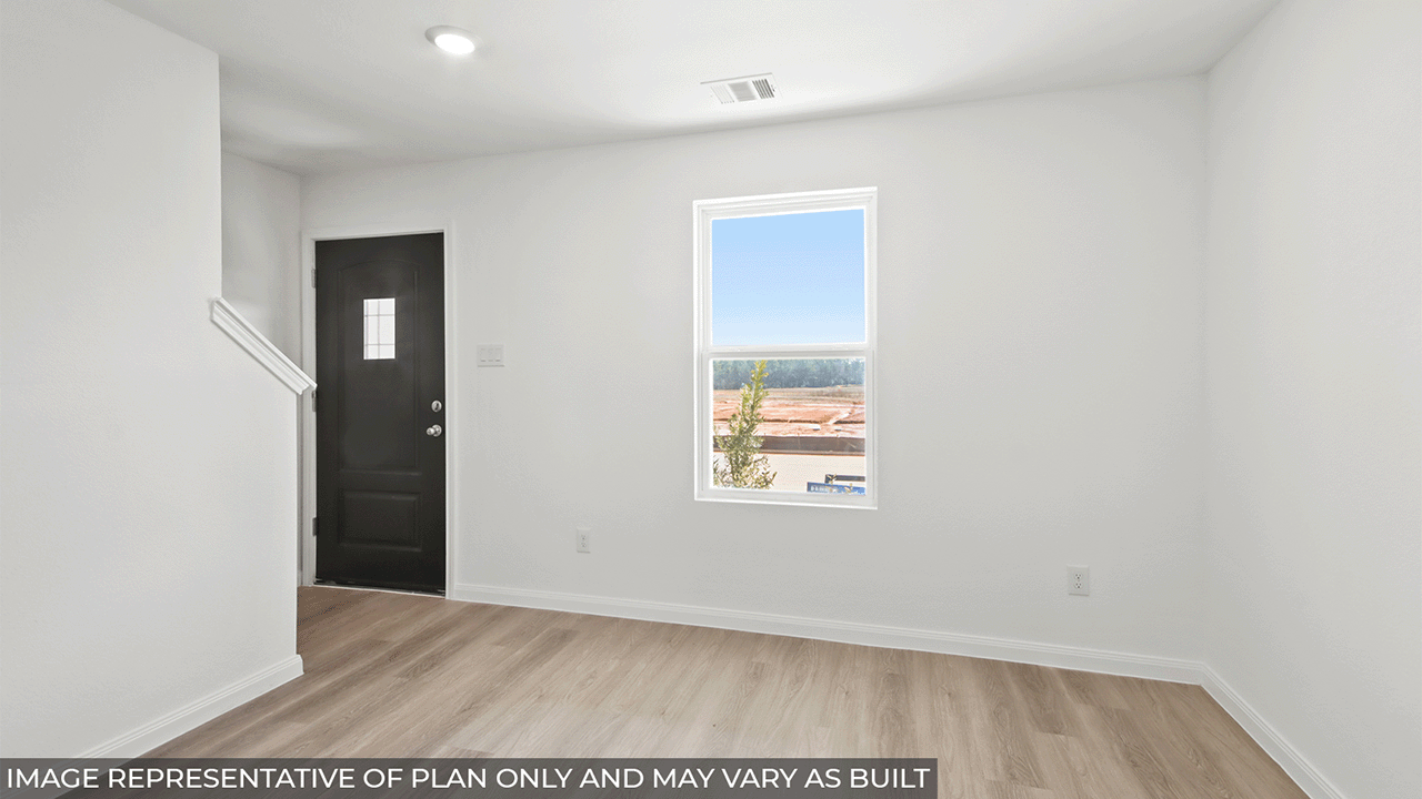 Spacious living area with vinyl flooring