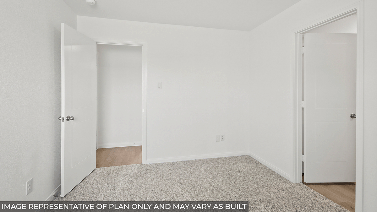 Primary bedroom with carpet flooring