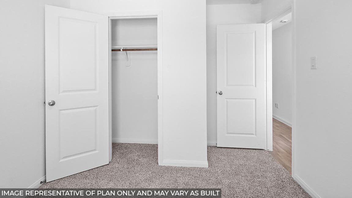 Primary bedroom with carpet flooring
