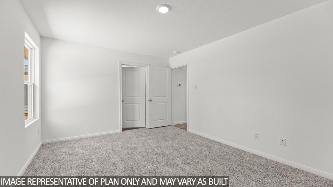 Primary bedroom with carpet flooring