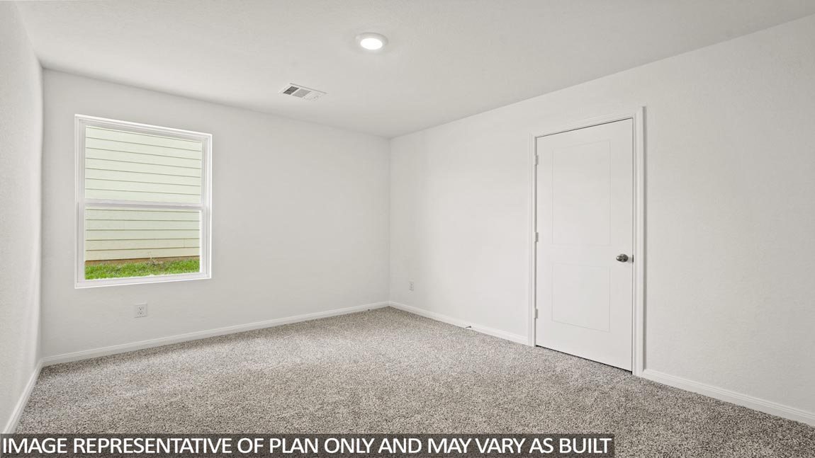 Secondary bedroom with carpet flooring