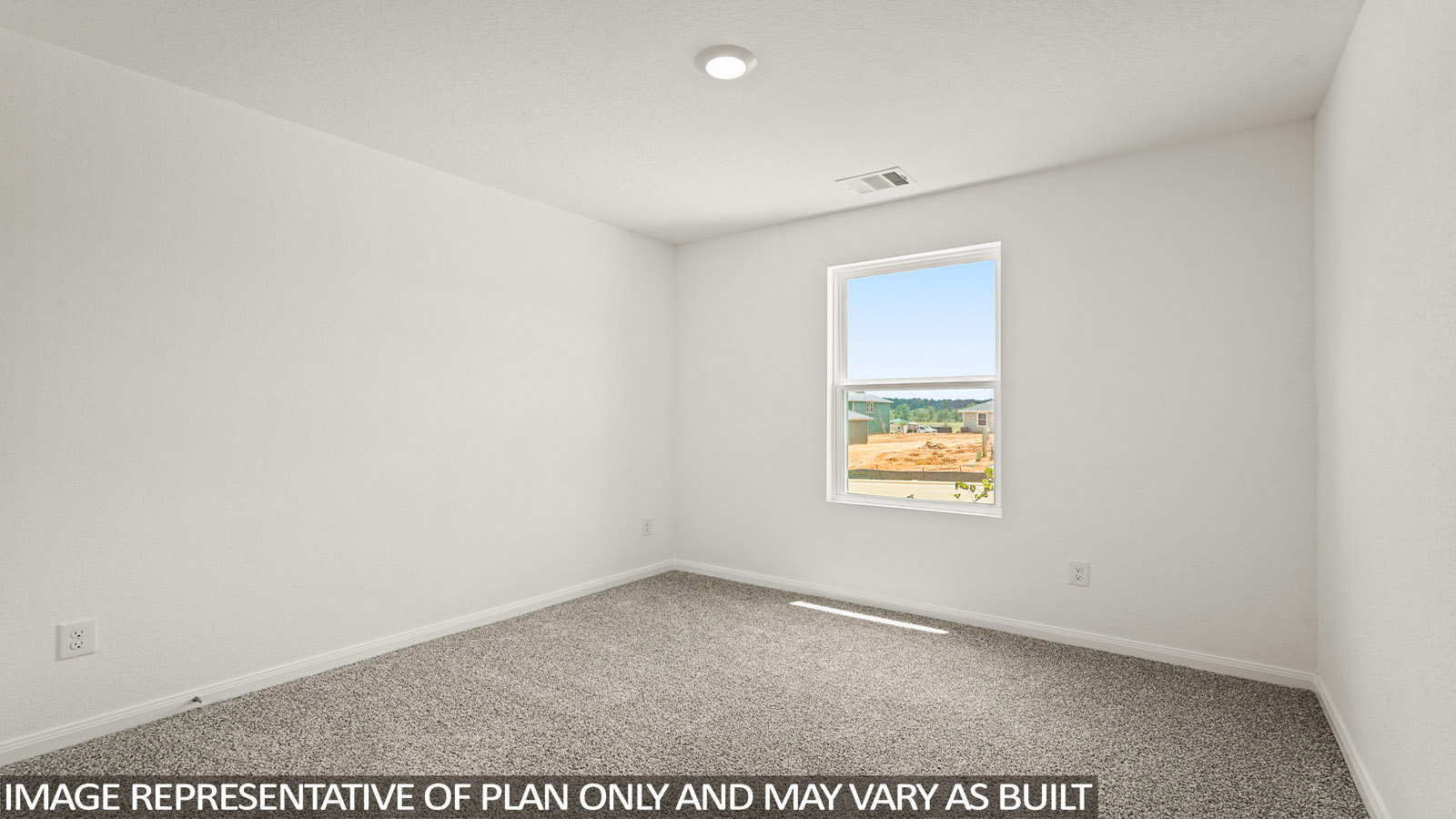 Secondary bedroom with carpet flooring