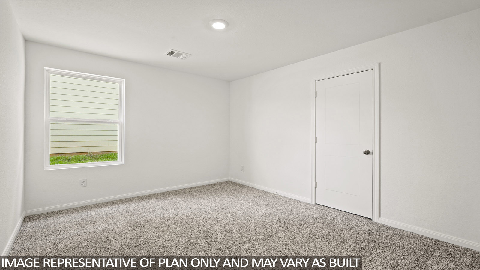 Secondary bedroom with carpet flooring