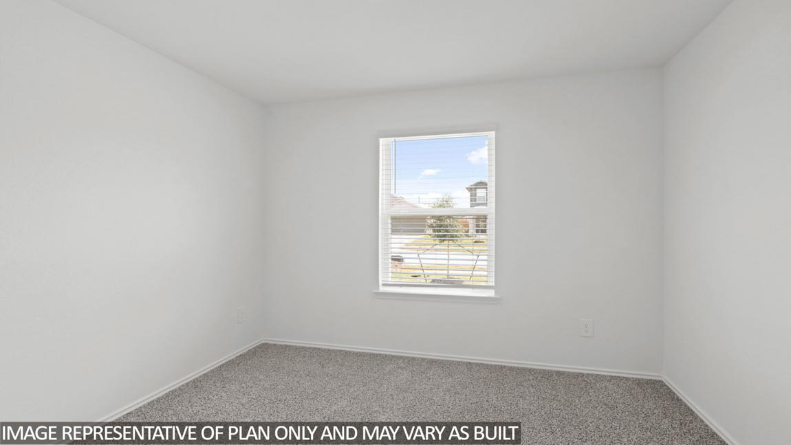 Secondary bedroom with carpet flooring