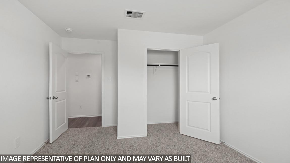 Secondary bedroom with carpet flooring