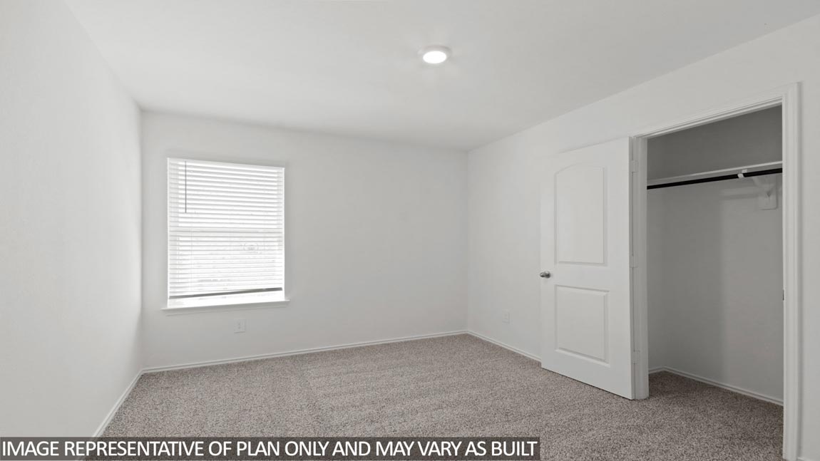 Secondary bedroom with carpet flooring