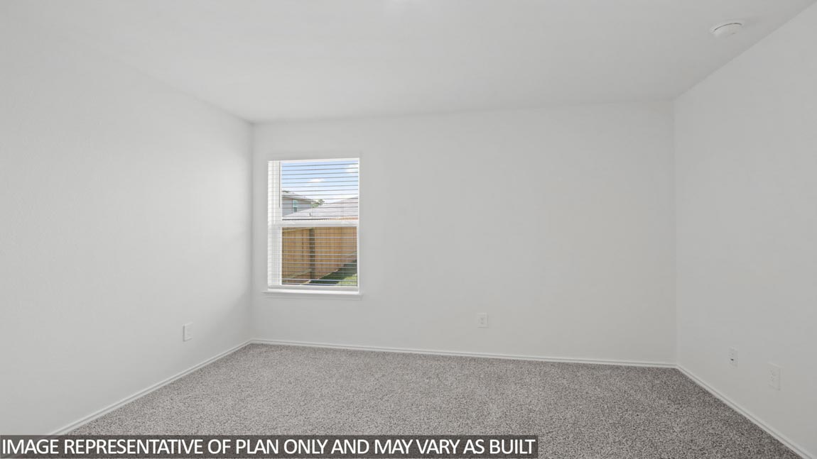 Primary bedroom with carpet flooring