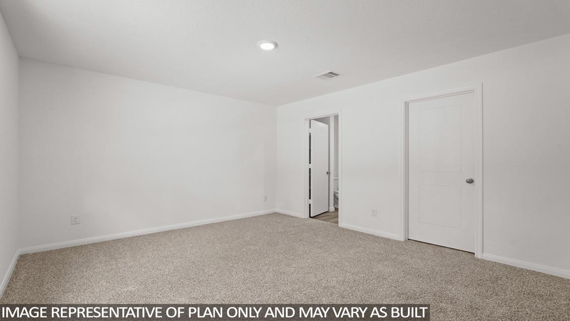 Secondary bedroom with carpet flooring